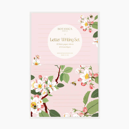 Apple Blossom Letter Writing Kit by Botanica Paper Co. The set comes with beautifully designed letter writing papers printed in full color. The front is adorned with apple blossoms and sweet honey bees.